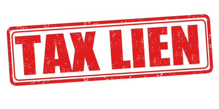 The Phrase “Tax Lien” in red, stamped on a white background. IRS Tax Lien concept.